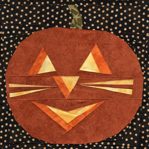 A Halloween Cat Face Curved Jack-O-Lantern Quilt Pattern